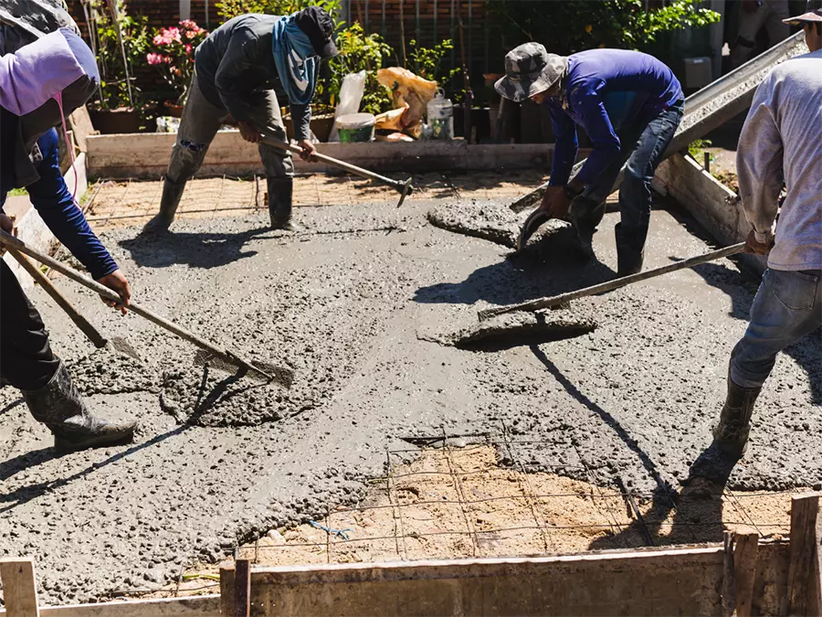 Cement floor polishing in Quail Village with workers smoothing fresh concrete