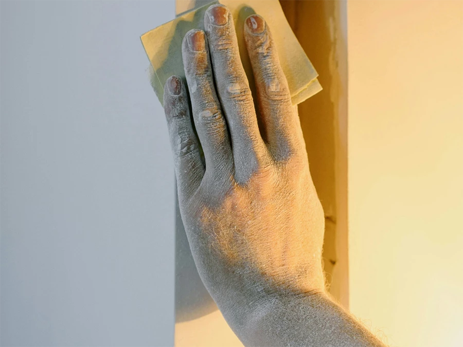 Floor polishing concrete in Gulf Coast with a hand using a sanding tool