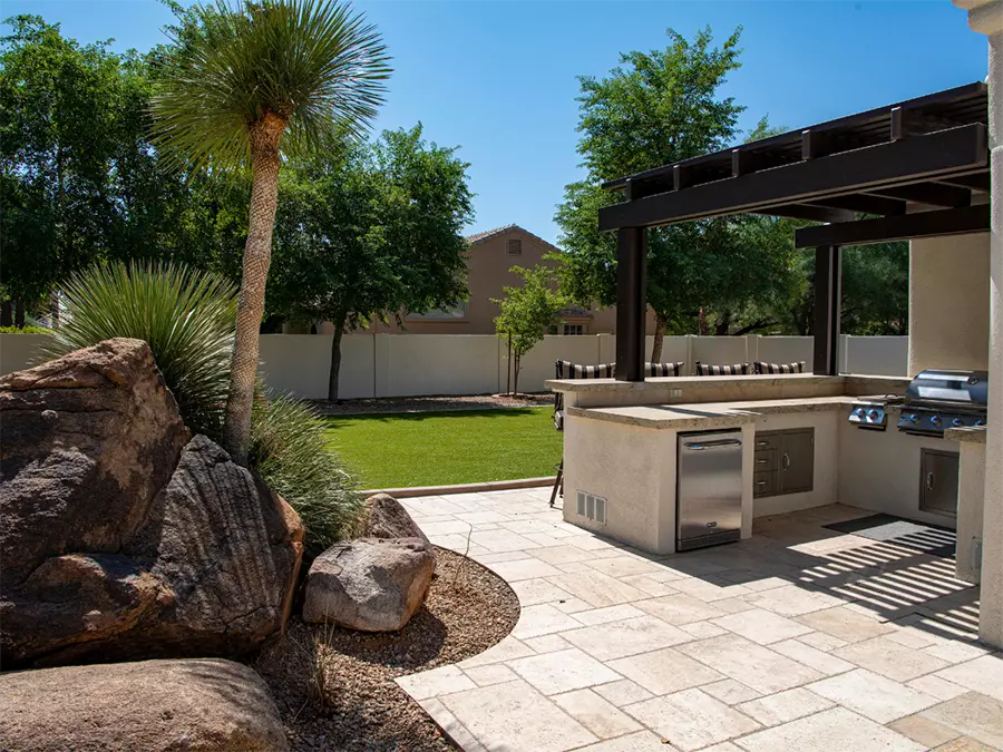 Stylish outdoor kitchen area with polished concrete flooring, showcasing Local concrete polishing in The Fountains under a shaded pergola