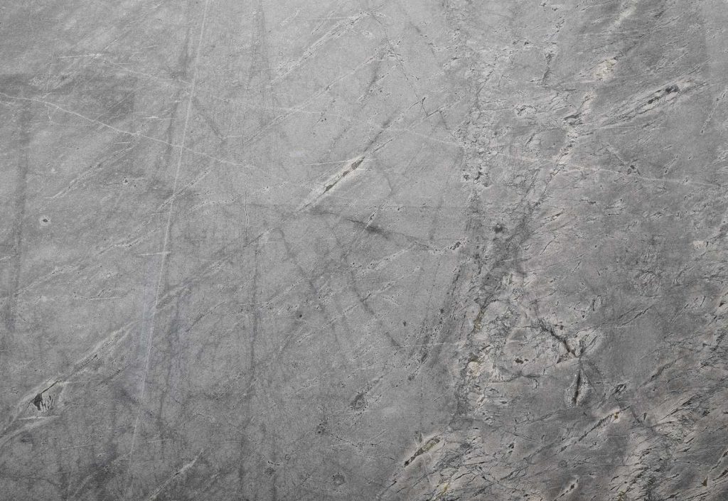 Dark gray cement texture with distinct vein lines, perfect for marble-look finished cement flooring Houston projects.