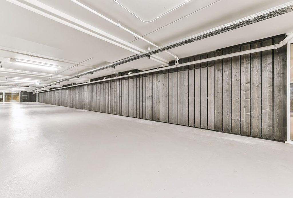 Bright, clean, and durable garage floor storage with white epoxy coating by a cement polishing company houston.