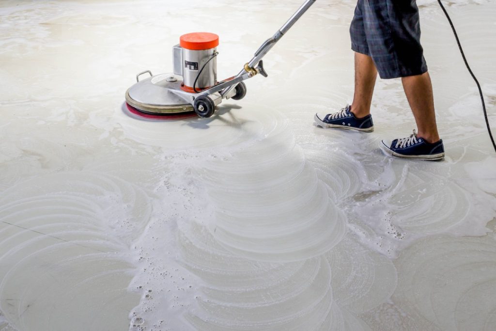 Commercial floor finishing and cleaning by a local polished concrete company Houston team for a high-gloss surface.