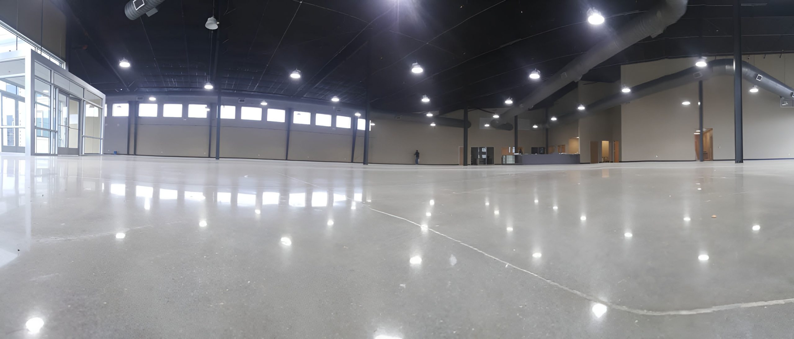 Spacious commercial interior featuring high-gloss concrete flooring completed by experts providing polished cement services San Antonio.