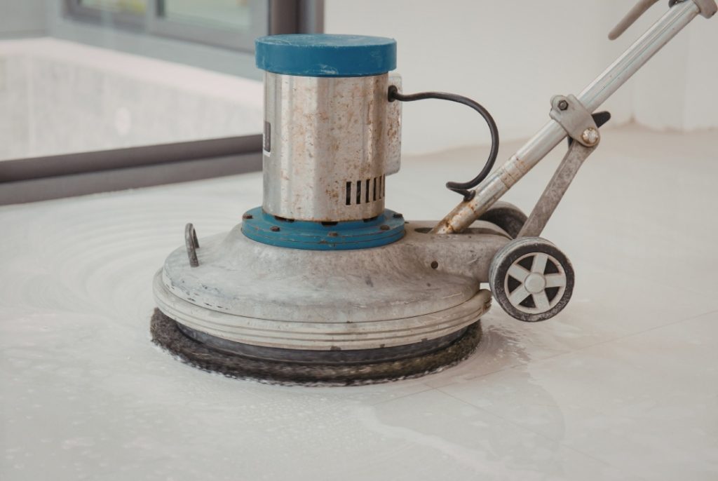 Using a heavy-duty floor buffer to create high-gloss finished concrete flooring Houston showroom floors.
