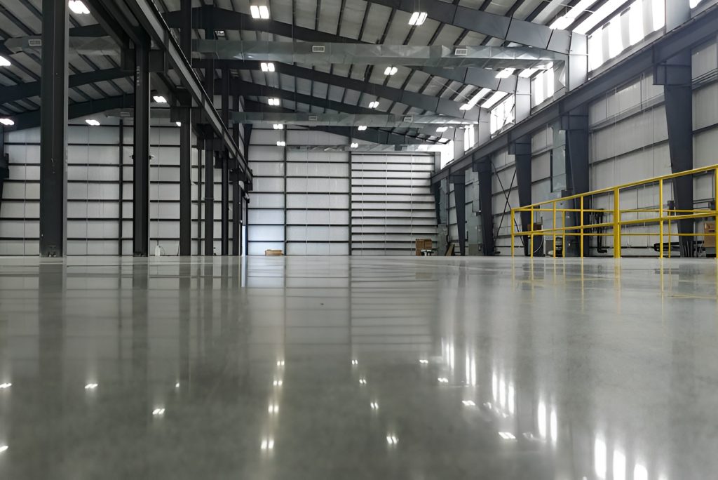 Massive industrial warehouse with high-gloss polished concrete flooring Austin designed for heavy machinery use.
