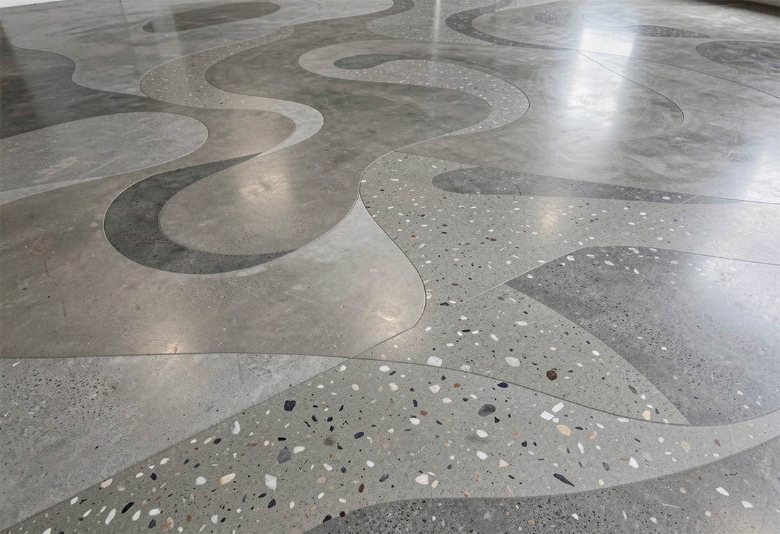 Polished concrete floors in Houston featuring decorative terrazzo-style patterns, delivering a durable, modern, high-gloss finish.