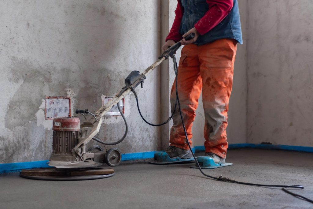 A skilled professional contractor performs cement polishing flooring Houston to create a high-quality surface.