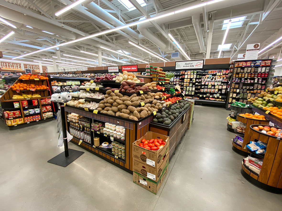Shiny cement flooring Dallas in a grocery store, creating a clean, modern look while supporting constant foot traffic and heavy rolling carts.