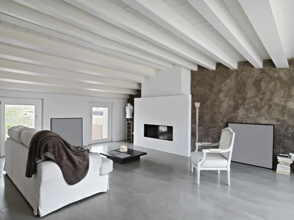 A modern loft-style living room with cacti and a fireplace features a sleek floor by a top Polished cement company houston.