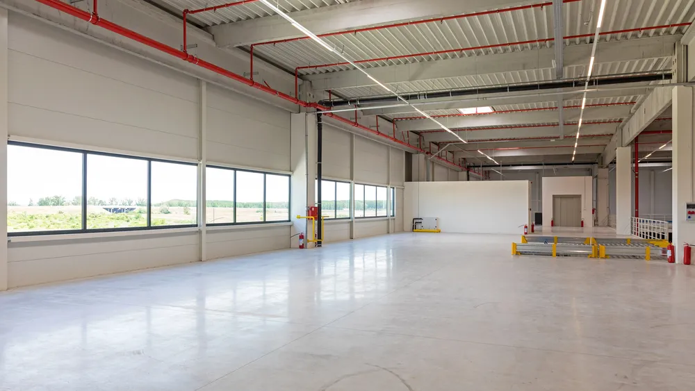 Polished concrete flooring Houston warehouse interior with modern finish, natural light, and durable industrial design.