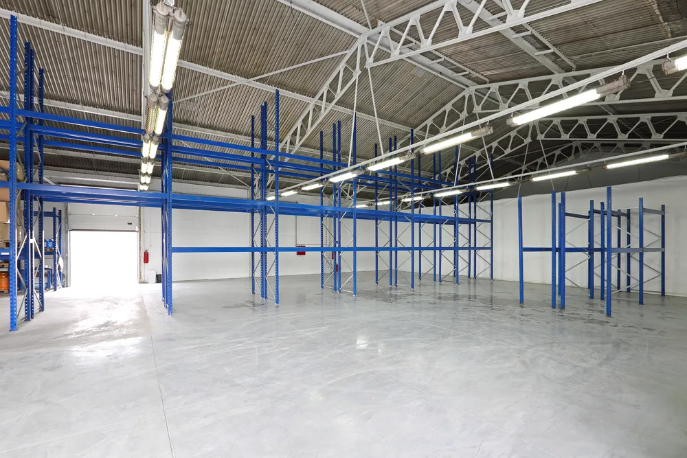 Spacious Houston warehouse featuring polished concrete flooring, tall storage racks, and organized distribution layout.