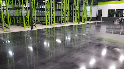 Polished concrete warehouse floor in Houston by expert cement polishing contractors for a durable, glossy finish.