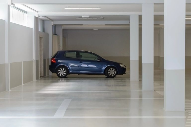 Polished cement floors in Houston showcasing a glossy finish in a modern living room with stylish furniture.