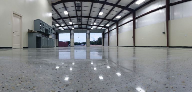 Spacious warehouse with polished cement floors, showcasing cement polishing company Houston services for a sleek finish.