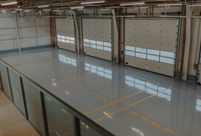 Cement polishing company Houston delivers high-gloss finish in spacious garage. Yellow floor markings reflect clean design.