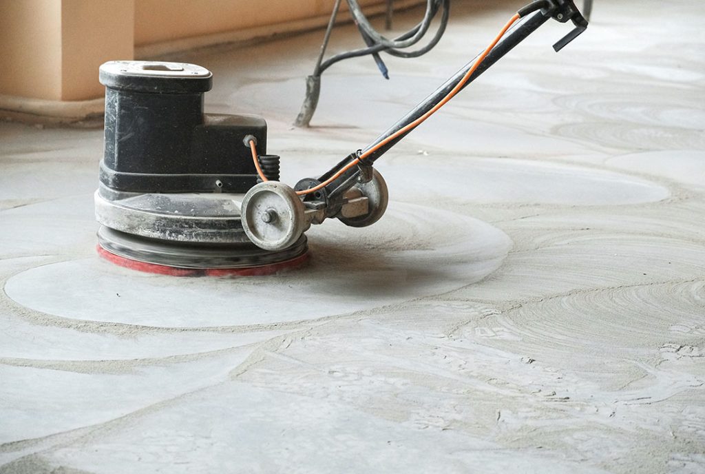 Industrial concrete grinding for surface preparation by polished concrete contractors Houston experts.