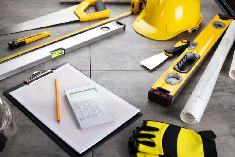 Project estimation tools used by polished concrete contractors Houston including levels, blueprints and calculator.