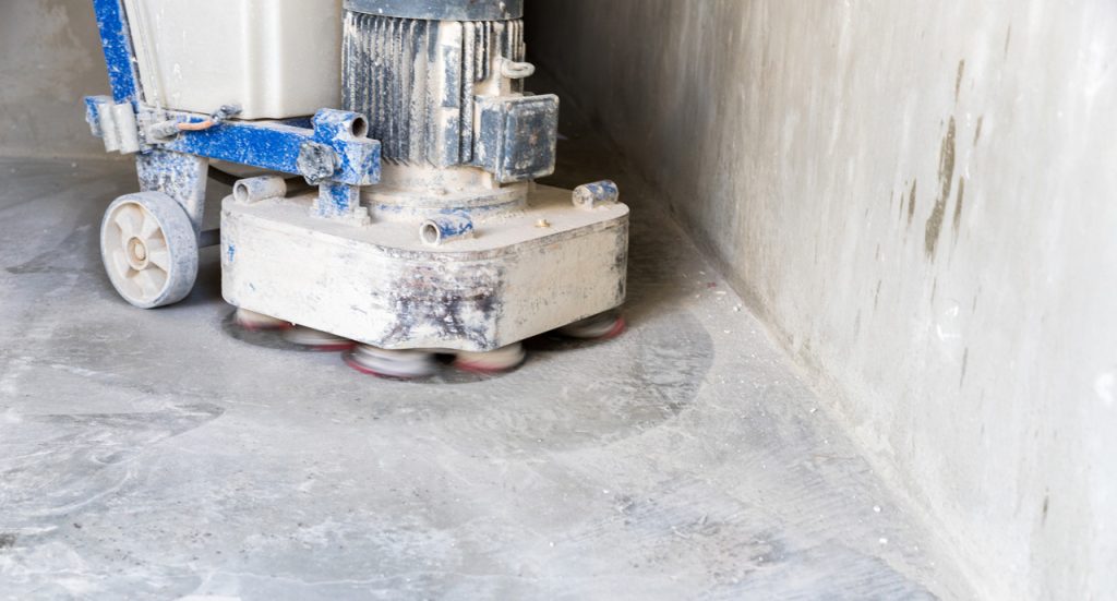 Professional industrial machine performing cement polishing flooring Houston for a smooth and glossy finish.