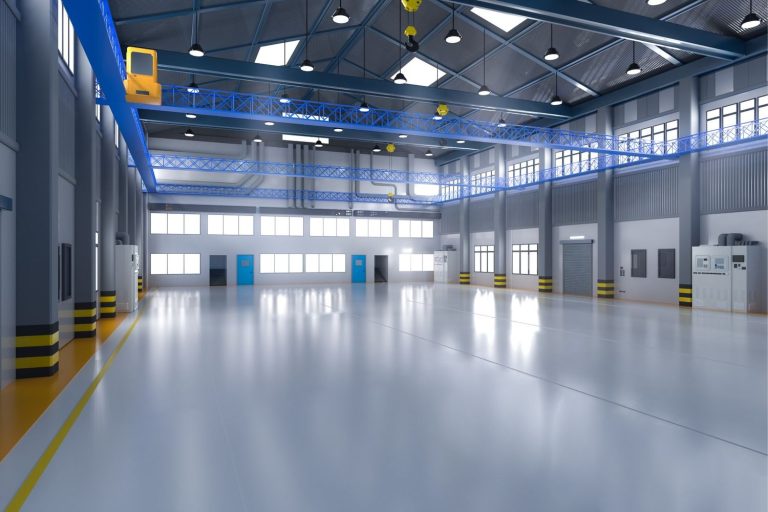 Large, modern manufacturing floor with a reflective, light-blue polished concrete finish from cement polishing contractors Houston.
