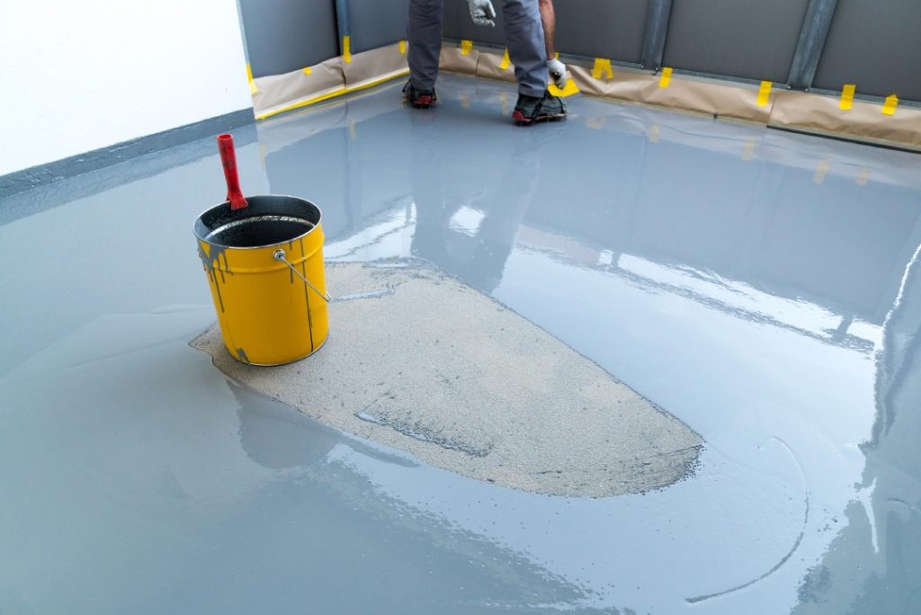 Professional grey epoxy coating and concrete polishing floors Houston installation for a durable industrial surface.