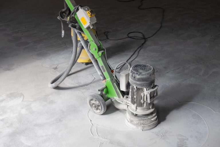 Industrial floor preparation using a heavy-duty grinder by a professional polished concrete company Houston experts.