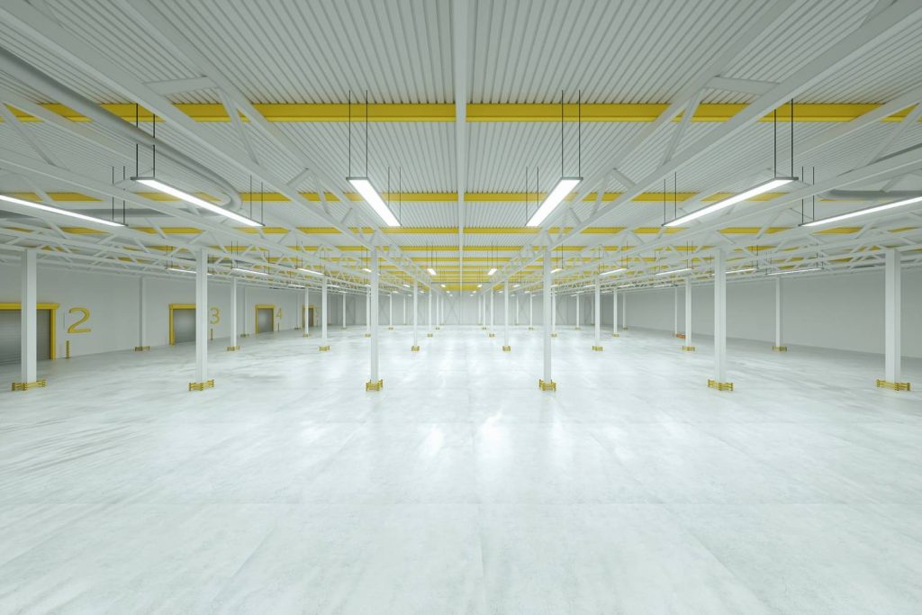 Bright modern distribution center showcasing high-gloss refinished concrete flooring Houston and white steel beams.
