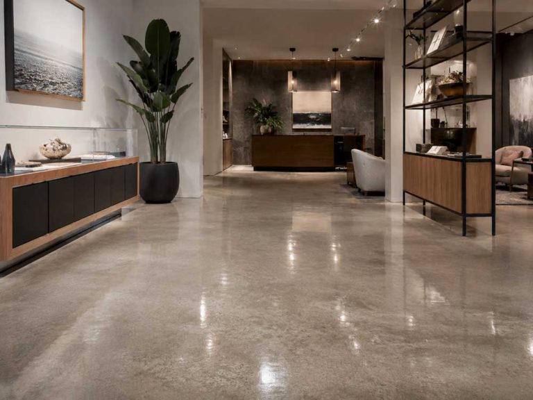 Modern open-concept living area featuring polished, refinished cement flooring Houston residential projects showcase.